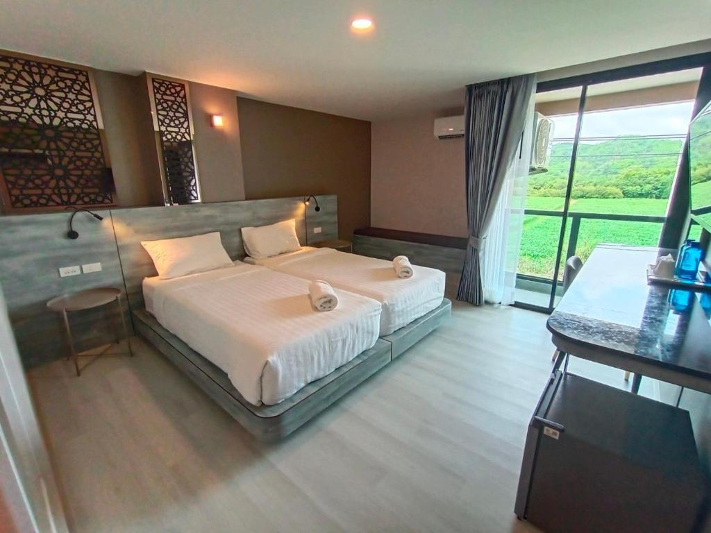 Postel nebo postele na pokoji v ubytování วัน บัดเจท เชียงราย เชียงแสน One Budget Hotel Chiangrai Chiangsaen