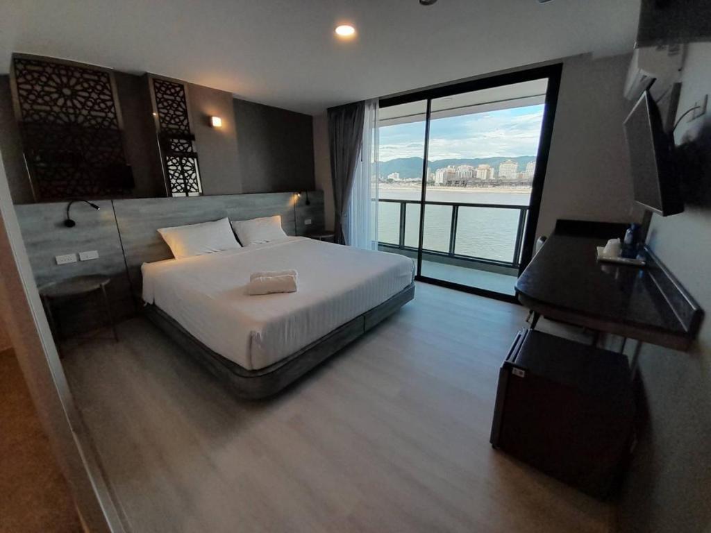 Postel nebo postele na pokoji v ubytování วัน บัดเจท เชียงราย เชียงแสน One Budget Hotel Chiangrai Chiangsaen