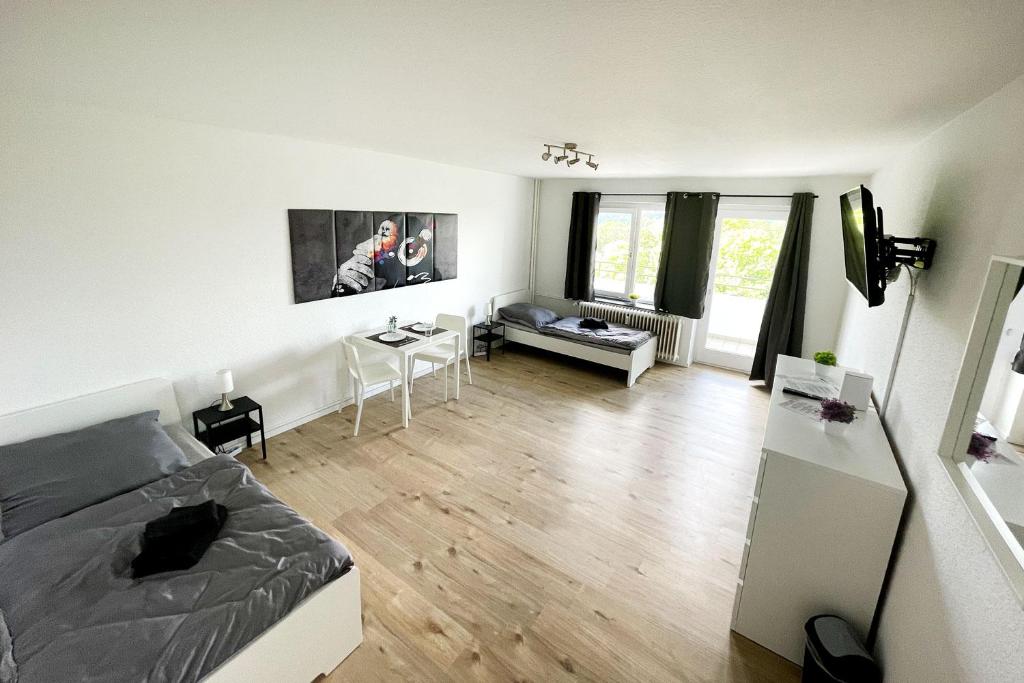 a living room with a bed and a table at Nice Appartement in Trappenkamp in Trappenkamp