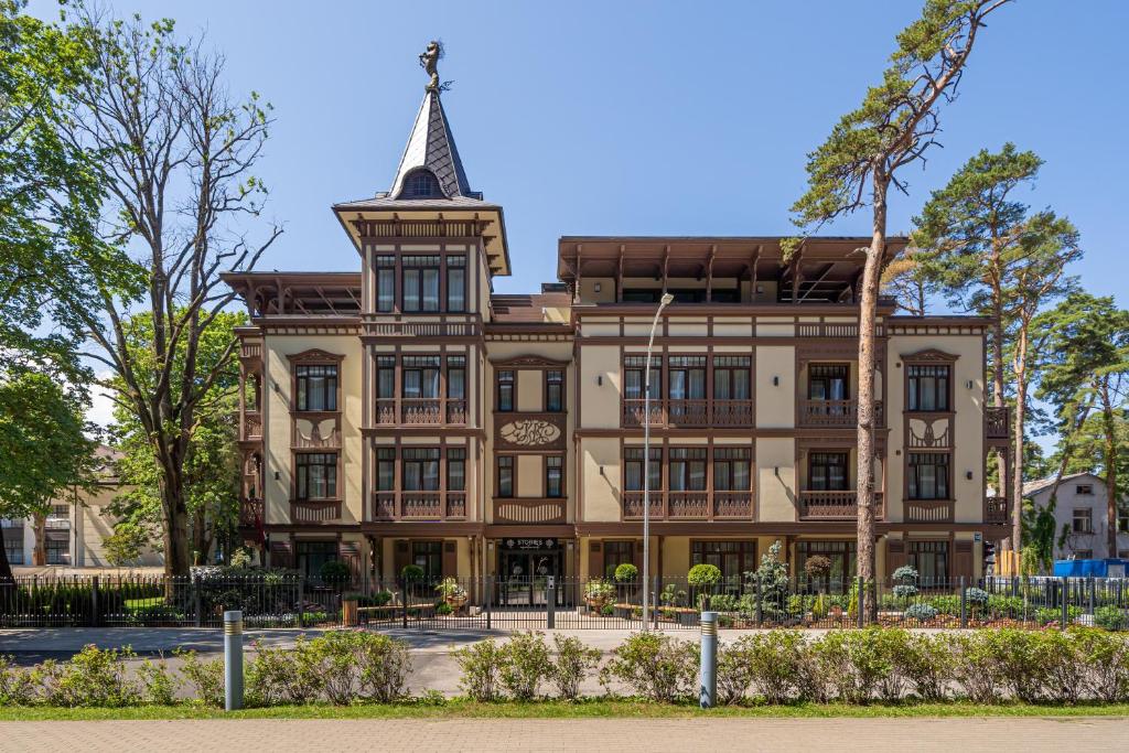 a large building with a tower on top of it at STORIES Design ApartHotel in Jūrmala