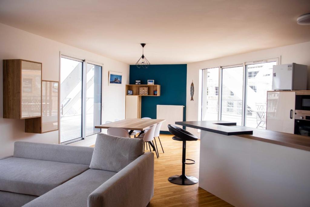 a living room with a couch and a table at spacious and bright apartment in Bordeaux