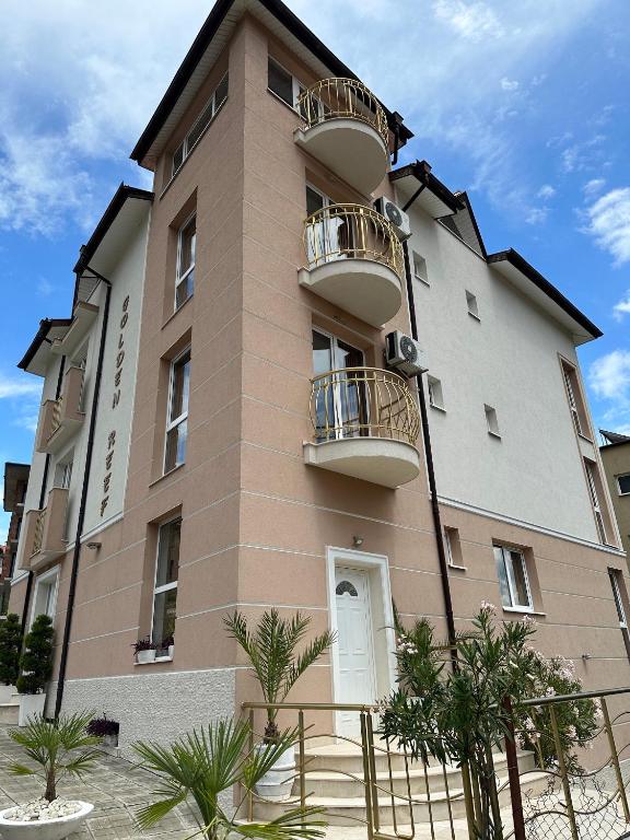 a building with balconies on the side of it at Къща за гости Golden Reef in Tsarevo