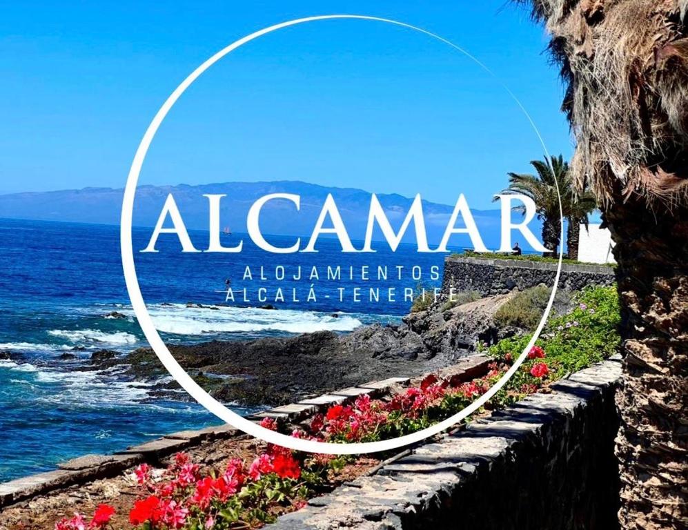 a sign that reads alamaran welcomes african learners at a beach at ALCAMAR Brand apartment with 2 bedroom and private bathroom near the sea! in Alcalá