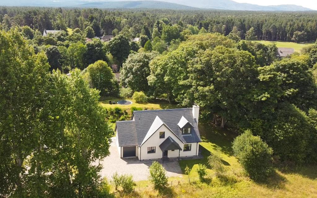 an aerial view of a house in the woods at Balnagowan Cottage in Nethy Bridge