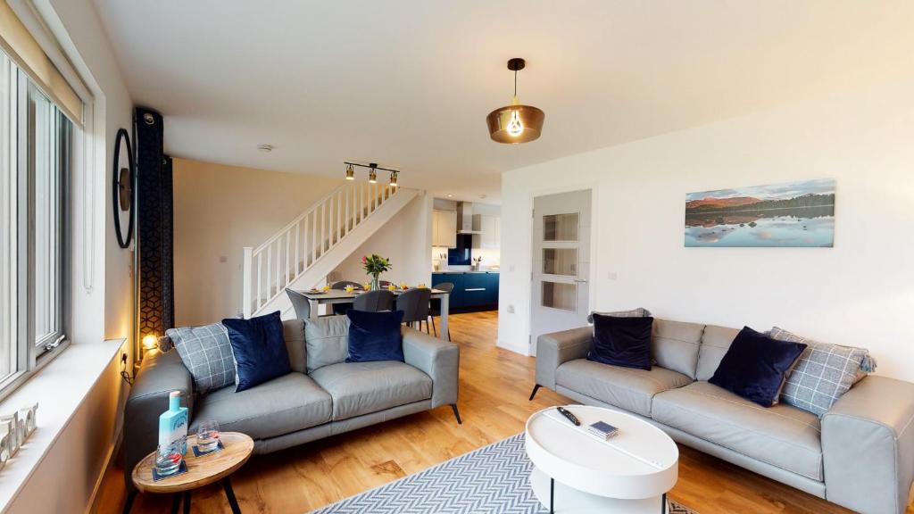 a living room with two couches and a table at 31 Caledonia Place in Aviemore