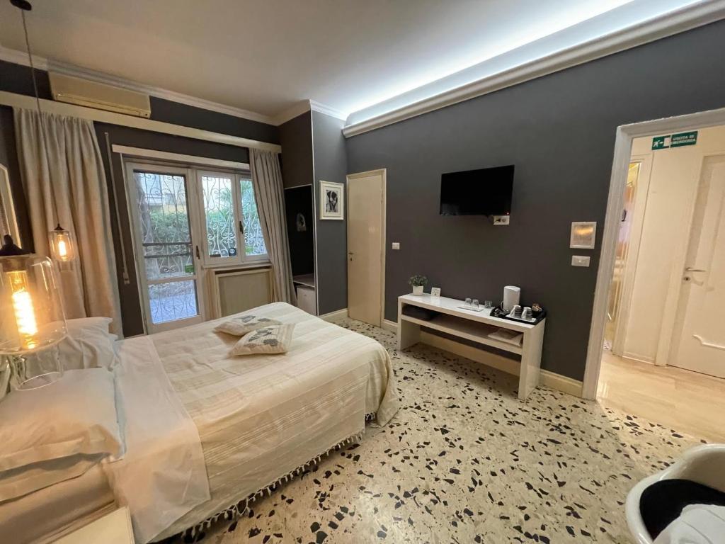 Posteľ alebo postele v izbe v ubytovaní B&B Tiburtina Garden