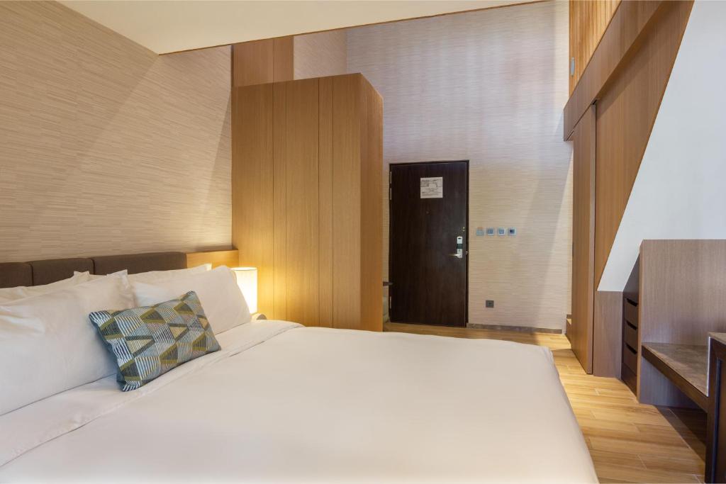 Postel nebo postele na pokoji v ubytování Kilin Hotel, JiaoXi