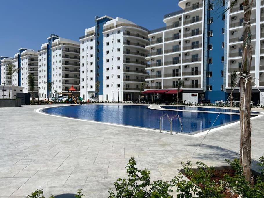 a large swimming pool in front of some buildings at New Sea View Flat in Long Beach in Perivolia tou Trikomou