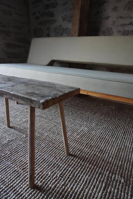 a bed sitting on top of a wooden table at Stodola Počúvadlo in Počúvadlo