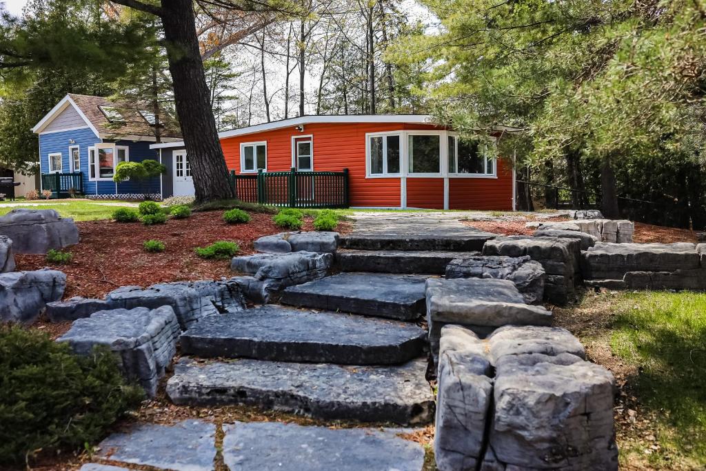 a garden with rocks in front of a house at The Dockhouse Cottage Five in Wasaga Beach