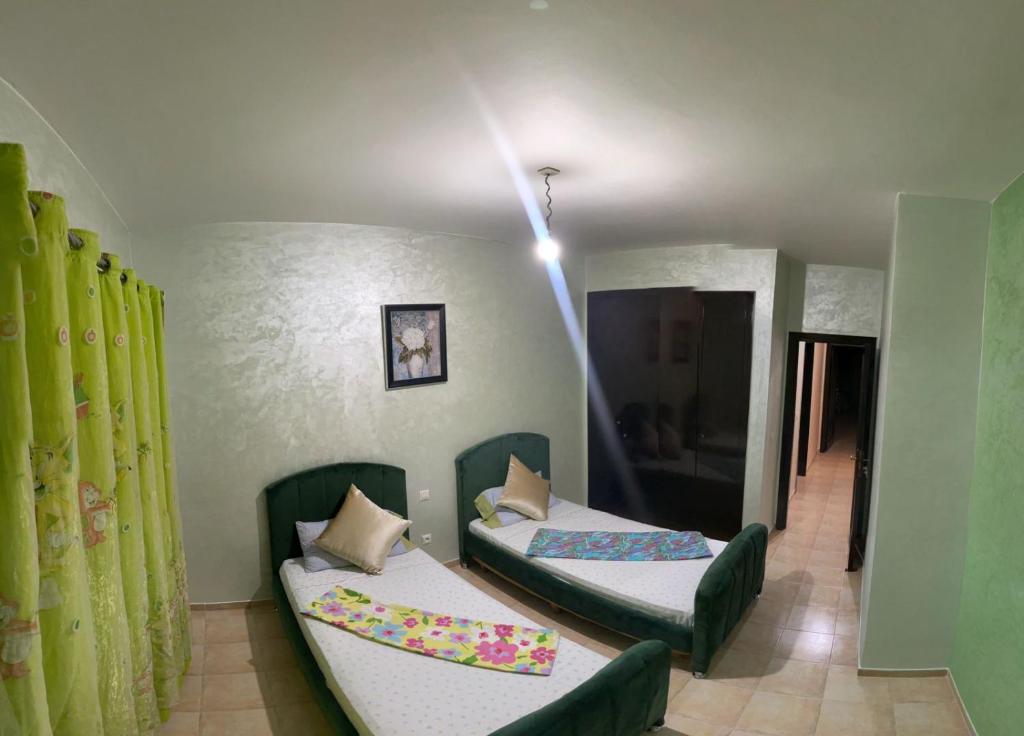 Postel nebo postele na pokoji v ubytování Appartement AP2 Résidence Al Waha