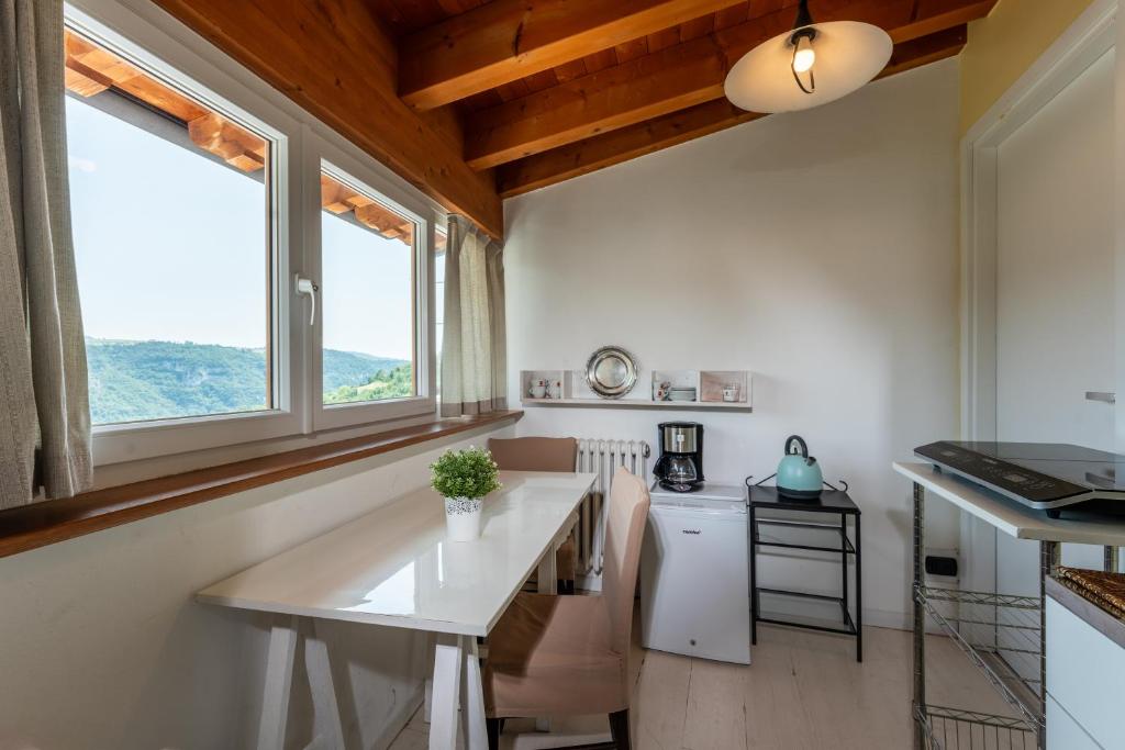 a kitchen with a white counter and two windows at BB Molina in Molina