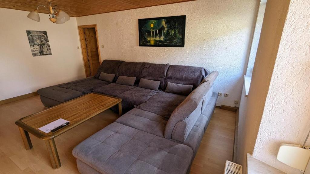 a living room with a couch and a table at Ferienwohnung Weber in Freyung