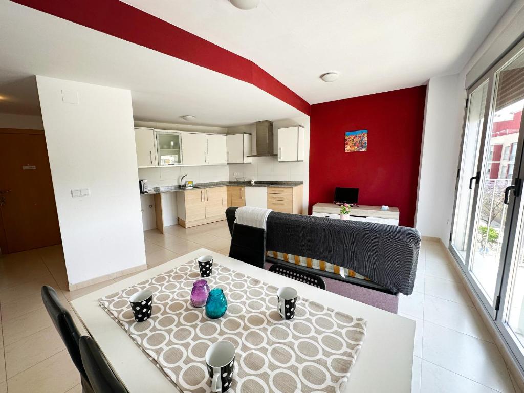 a kitchen and dining room with a table and chairs at Apartamentos Benicarló 3000 in Benicarló