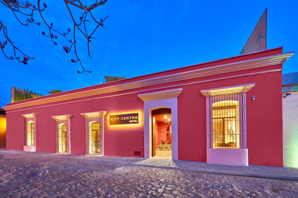 a red building with a store in it at City Centro by Marriott Oaxaca in Oaxaca City
