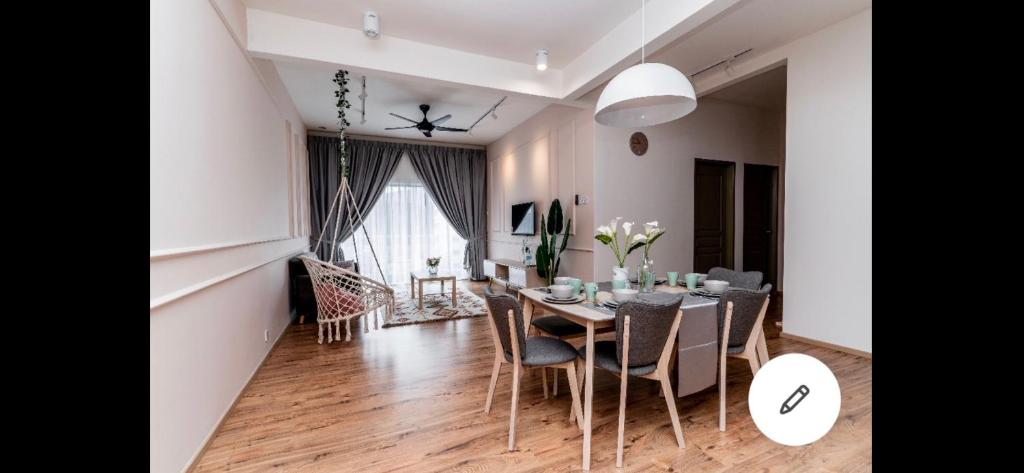 a dining room and living room with a table and chairs at City Retreat at Quintet(3BR/8pax) 9 Jalan PMCJ, Tanah Rata in Tanah Rata