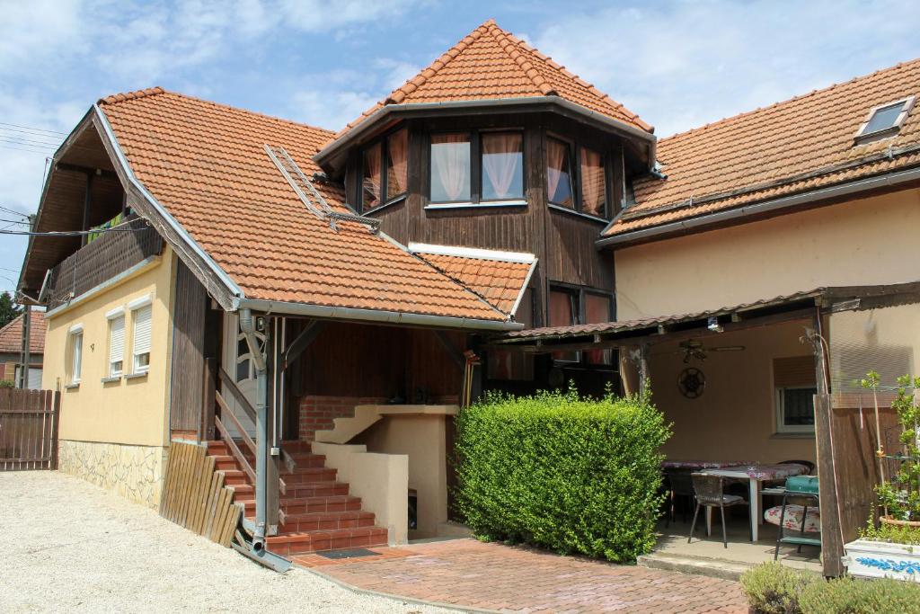 a house with an orange tile roof at Elena Apartaments in Sármellék