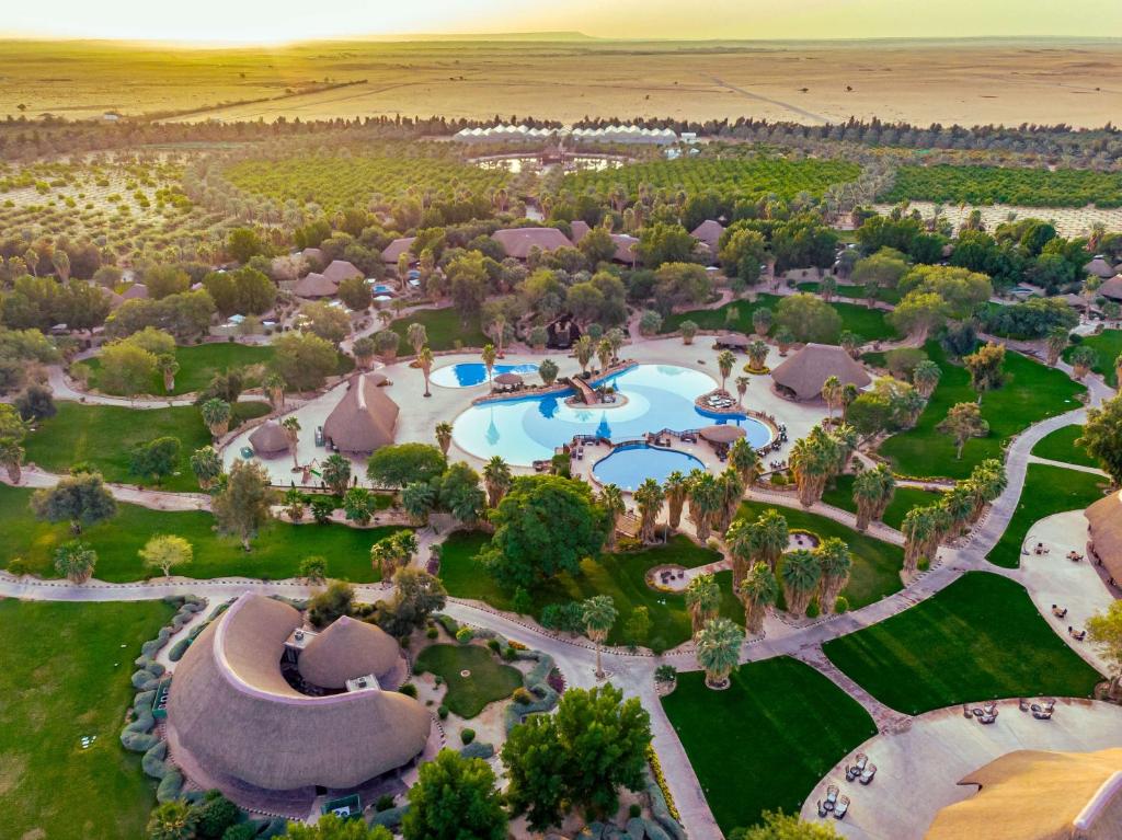 an aerial view of a resort with a pool at Nofa Riyadh, A Radisson Collection Resort in Ţibrāk