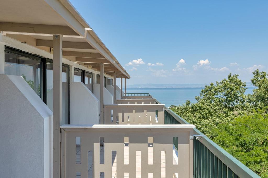 a balcony of a house with a view of the ocean at Sun Beach Hotel in Agia Triada
