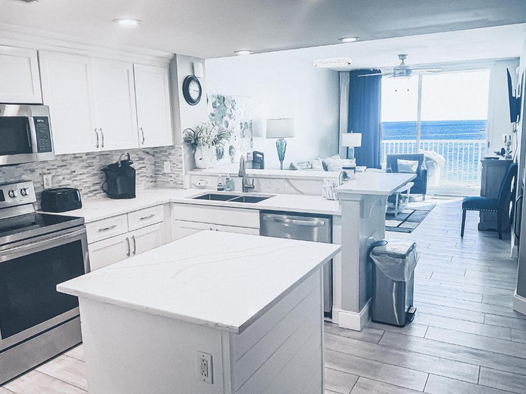 a kitchen with white cabinets and a counter top at Majestic Resort 505 with RESERVED parking on 3rd Floor Walk-Over in Panama City Beach
