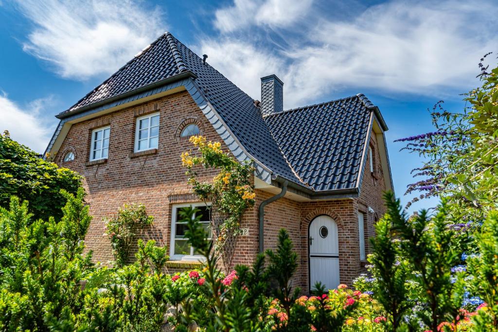 a brick house with a black roof at Landhaus Nici in Westerland (Sylt)