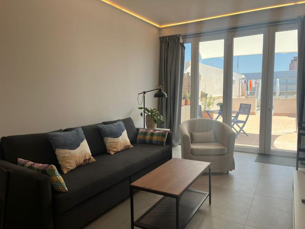 a living room with a couch and a chair and a table at Penthouse Mentidero Loft Grupo AC Gestión in Cádiz