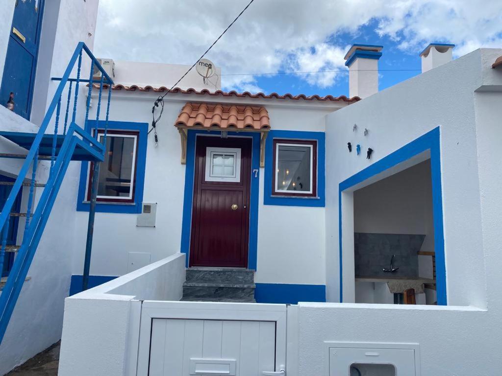 a blue and white house with a red door at Charming Amieira's Alqueva in Amieira