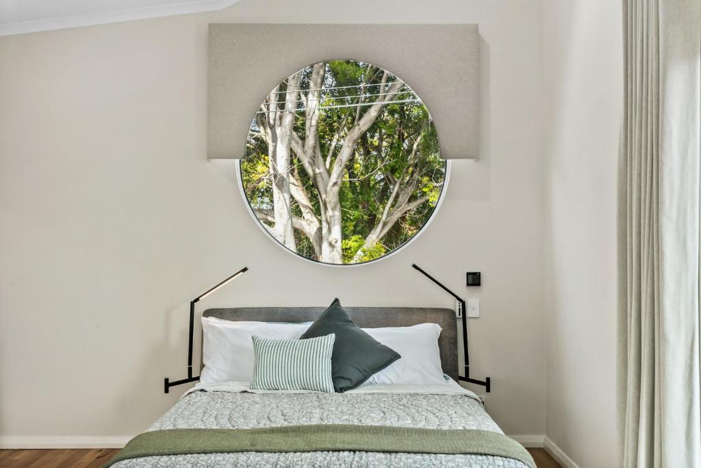 a bedroom with a bed with a mirror above it at Gumtree Studio - Luxury 1 Bed Studio in Perth