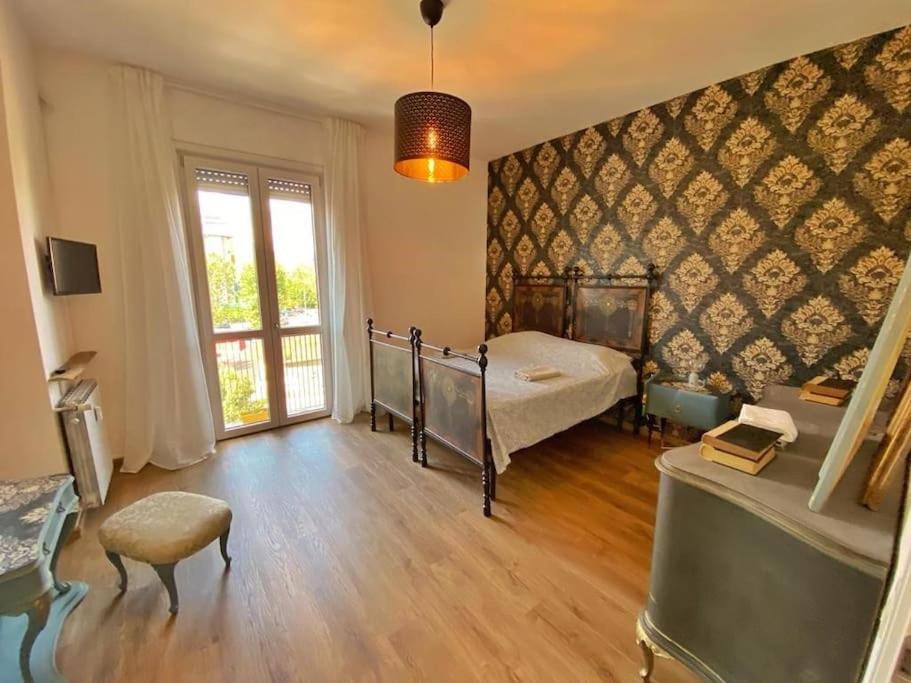 a bedroom with a bed and a large window at Fevira Suite Airport Free Parking in Florence