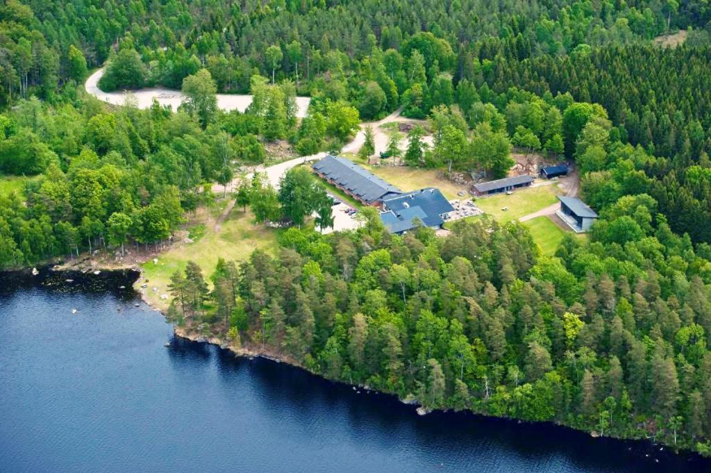 an aerial view of a house on an island in the water at Hotel Fritza - tidigare "Hotel Fritzatorpet" in Olofström