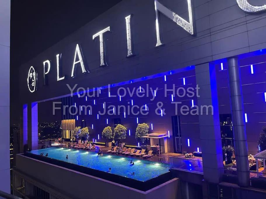 a sign on the side of a building with a pool at #5 KLCC Platinum Suites (Face Suites) 2BED 2BATH in Kuala Lumpur
