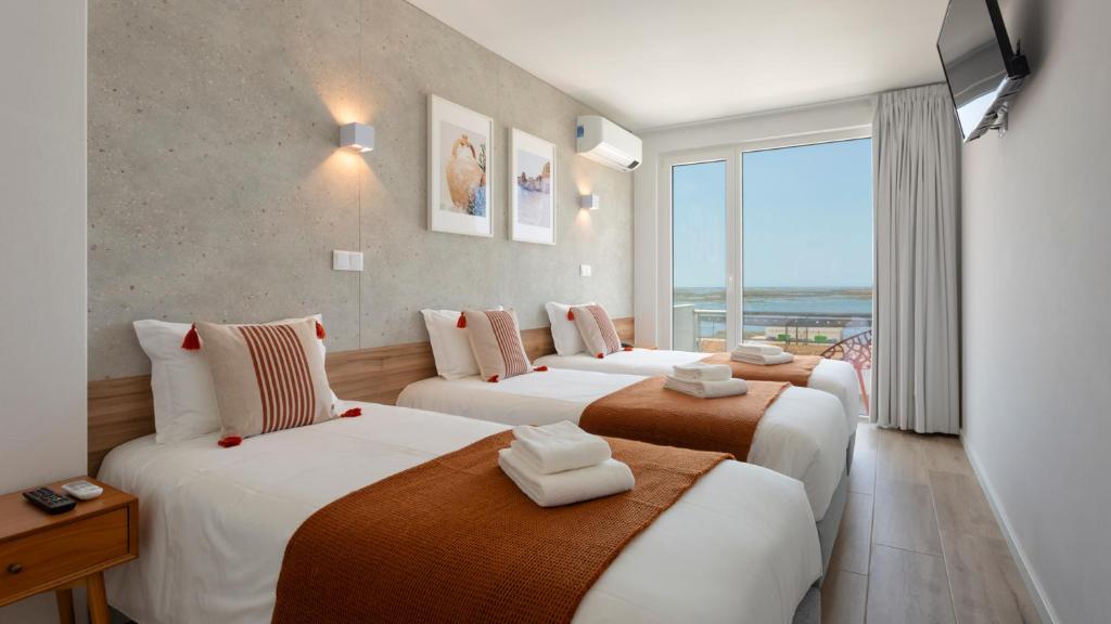 Postel nebo postele na pokoji v ubytování Hotel Made inn Faro