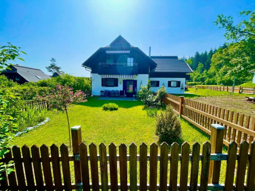 una casa con una valla delante de ella en Ferienwohnung mit Garten - a88519 en Feistritz im Rosental