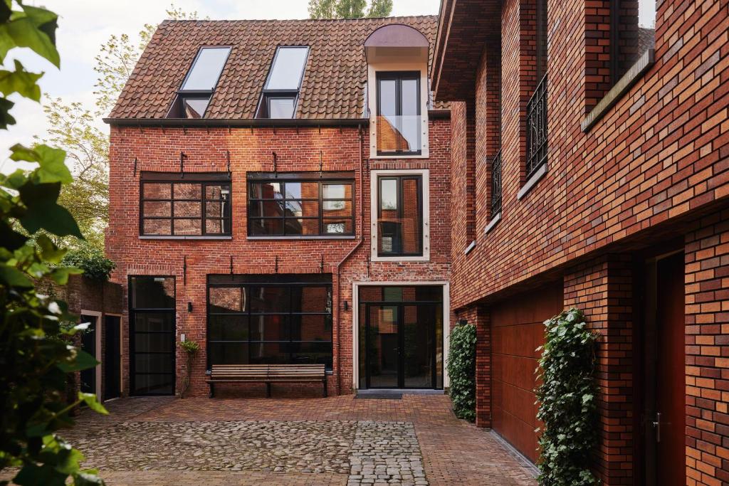 a brick house with a courtyard in front of it at Business Guesthouse in Groningen