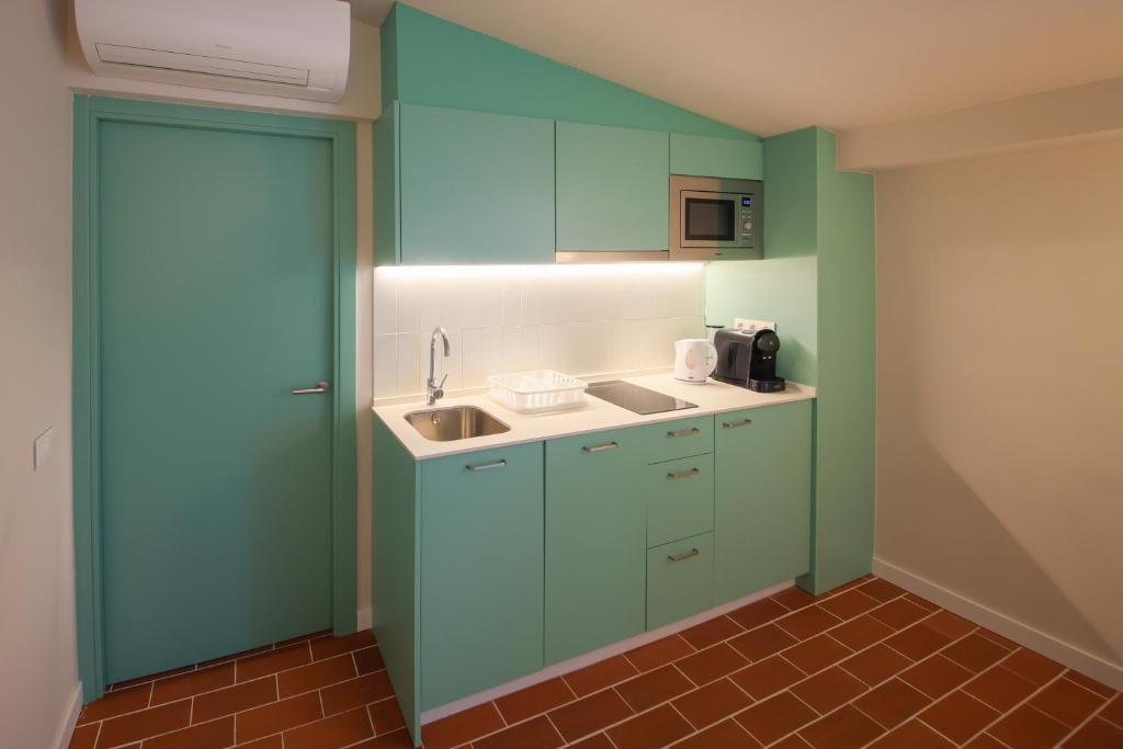 Kuchyň nebo kuchyňský kout v ubytování Terra Aurea Aparthotel