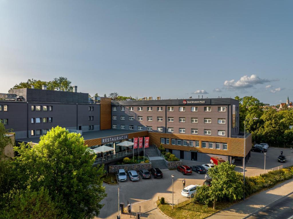 an overhead view of a building with a parking lot at Best Western Plus Hotel Olsztyn Old Town in Olsztyn