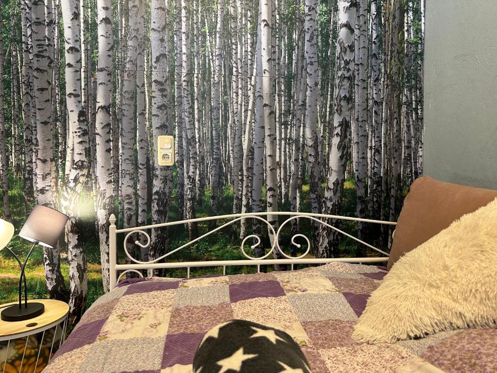 a bedroom with a bed with a mural of aspen trees at Roggendorf in Mechernich