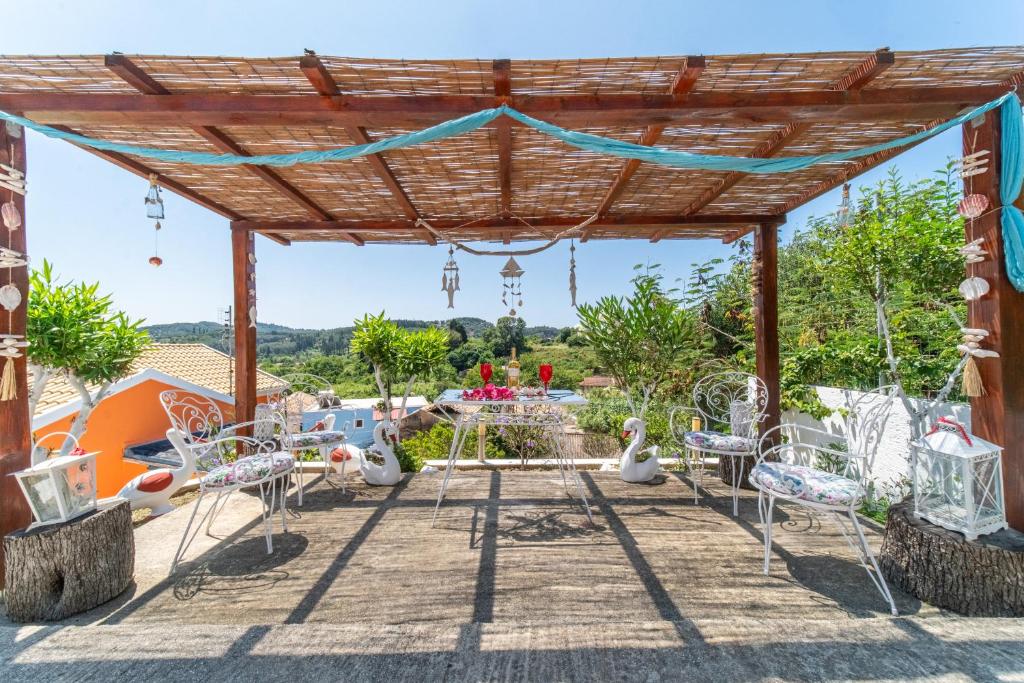 a patio with chairs and a pergola at Kohili Retreat in Peroulades