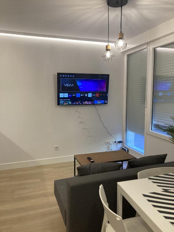 A television and/or entertainment centre at Bravo Murillo Apartments