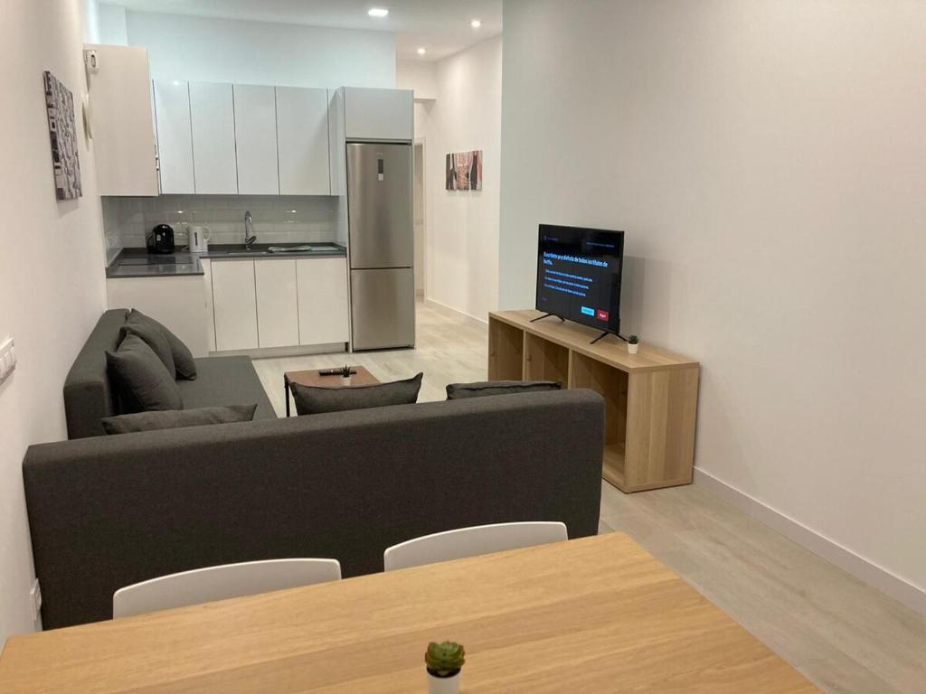 a living room with a couch and a kitchen at Matadero Apartments 3 in Madrid