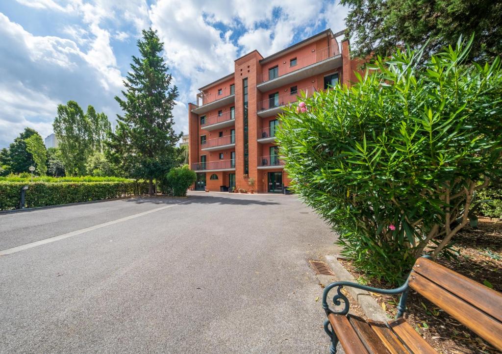 a park bench in front of a building at Casa Betania in Pisa