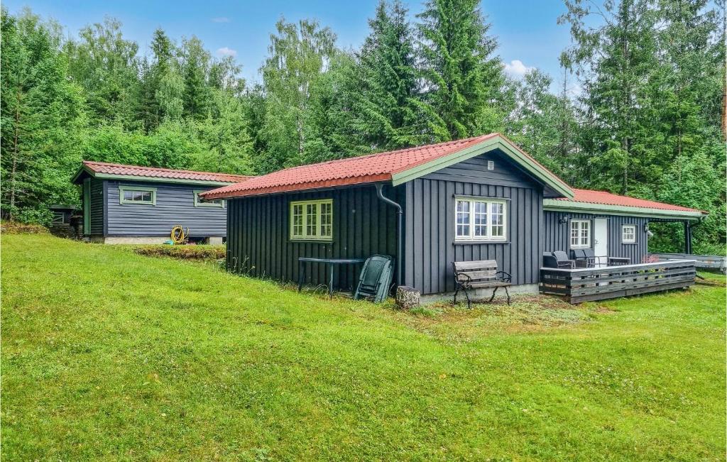 a small cabin in a yard with a grass field at Nice Home In Sagstua With Lake View 