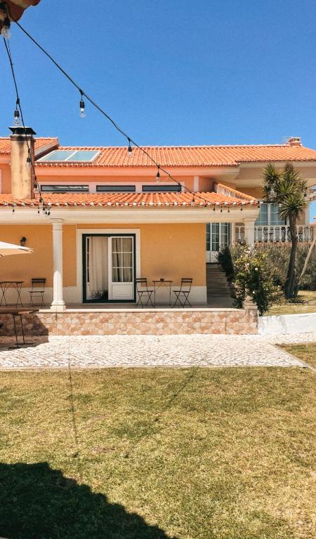 a house with a lawn in front of it at Quinta Amarela - B&B in Nazaré