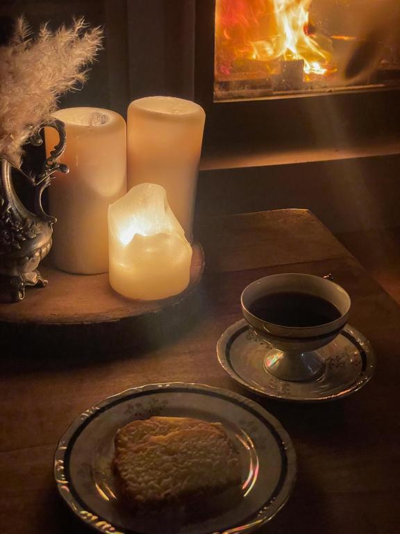 a table with a plate of bread and candles at Quinta Amarela - B&B in Nazaré