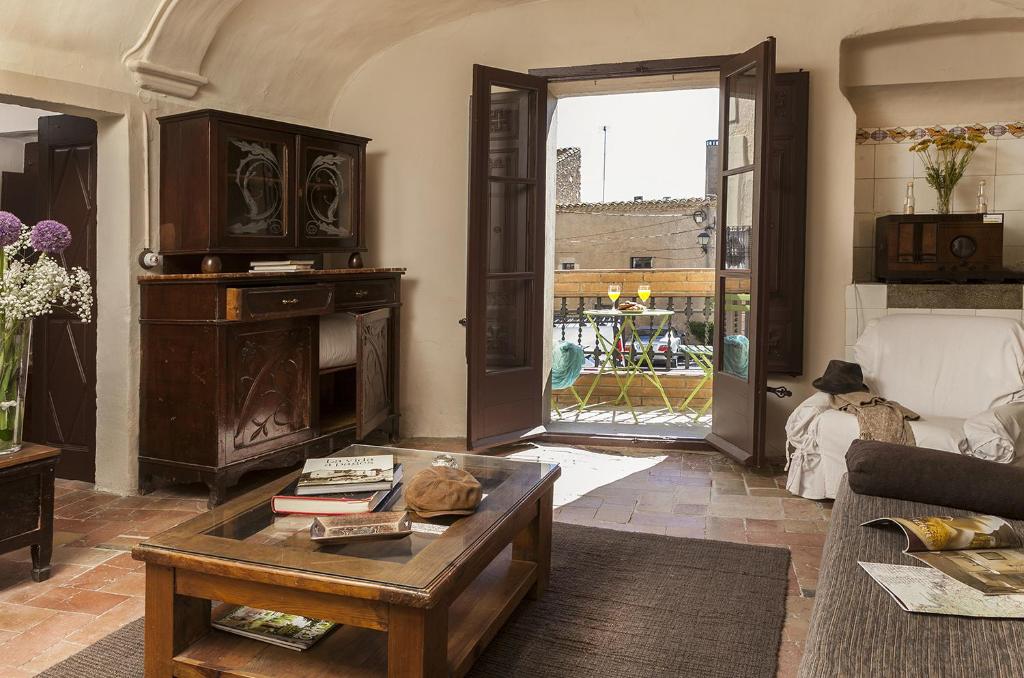 a living room with a couch and a coffee table at Can Barrina in Ventalló