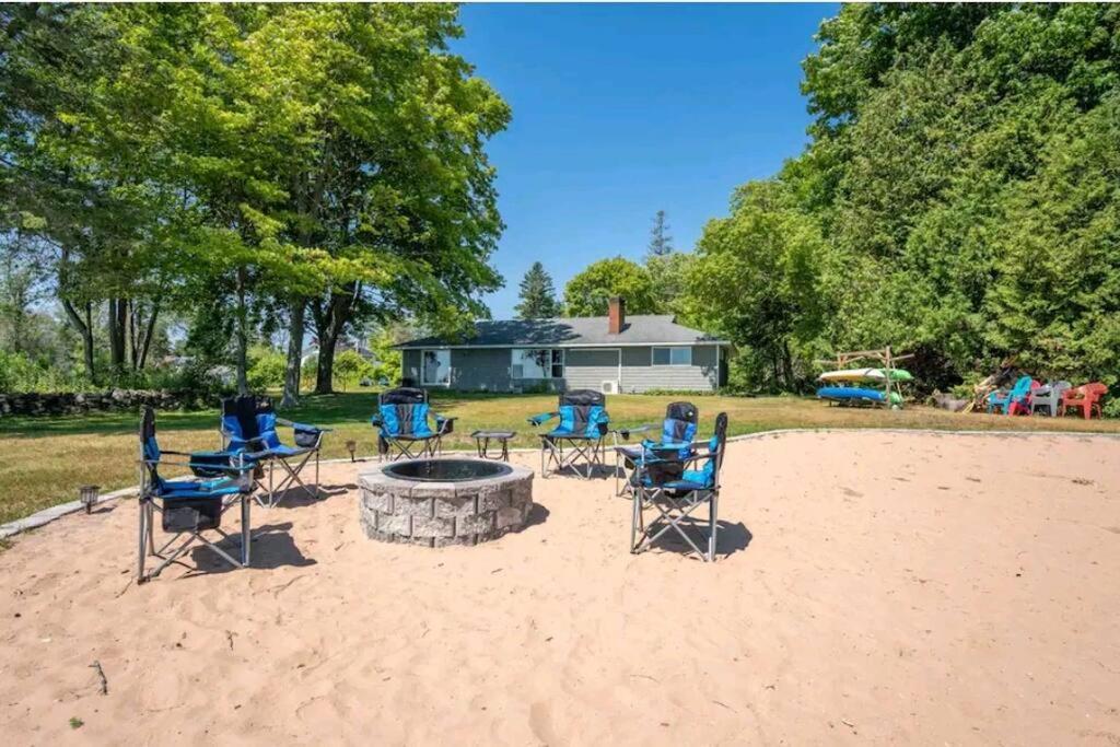 a group of chairs sitting around a fire pit at Beautiful home on Lake Michigan, near Escanaba 