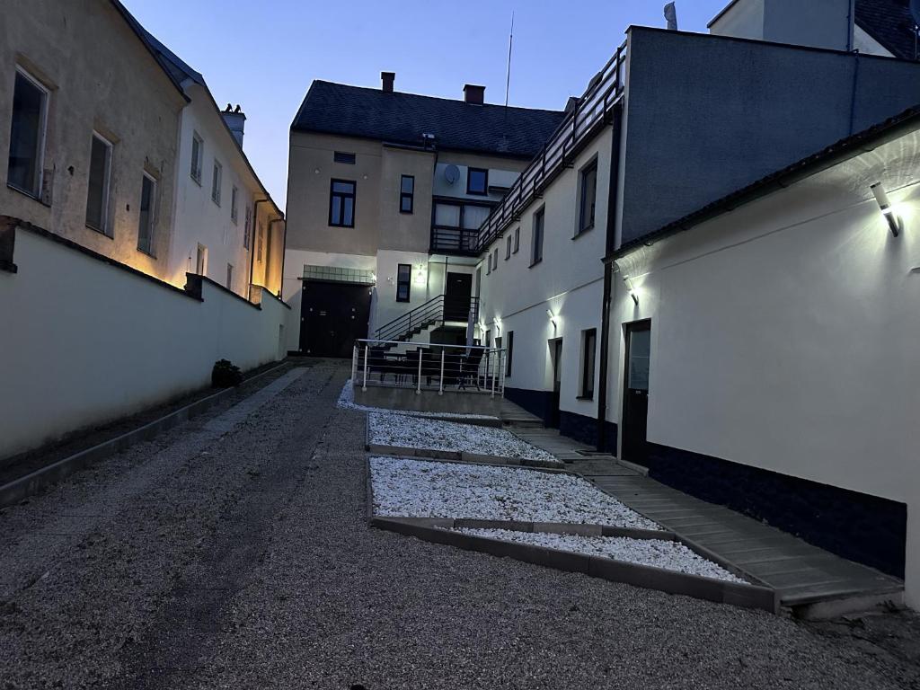 an alley with white buildings and lights on the side at Waldluft Apartments in Heidenreichstein