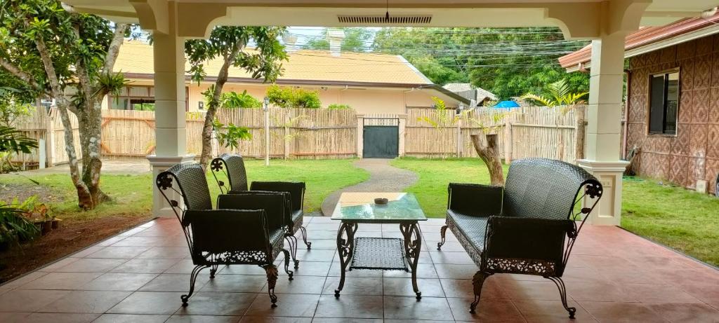 a patio with chairs and a table on a porch at DMC1 Residence Panglao in Panglao