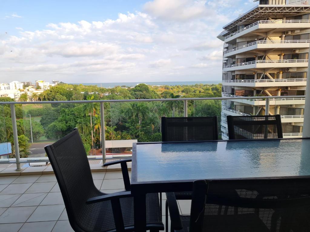 a table and chairs on a balcony with a view at Dashwood Dreaming - Room in Shared Apartment in Darwin