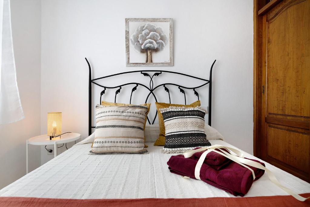 a bedroom with a bed with a black and white bedspread at Casa Cordel in Playa Honda